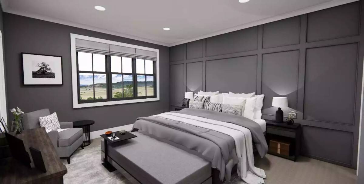 Primary bedroom with a cushioned armchair and a platform bed against the paneled accent wall.