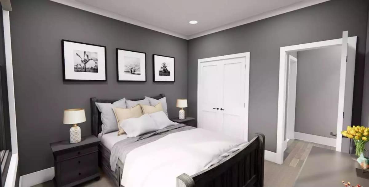 Secondary bedroom with dark wood furnishings and gray walls adorned with black and white artworks.