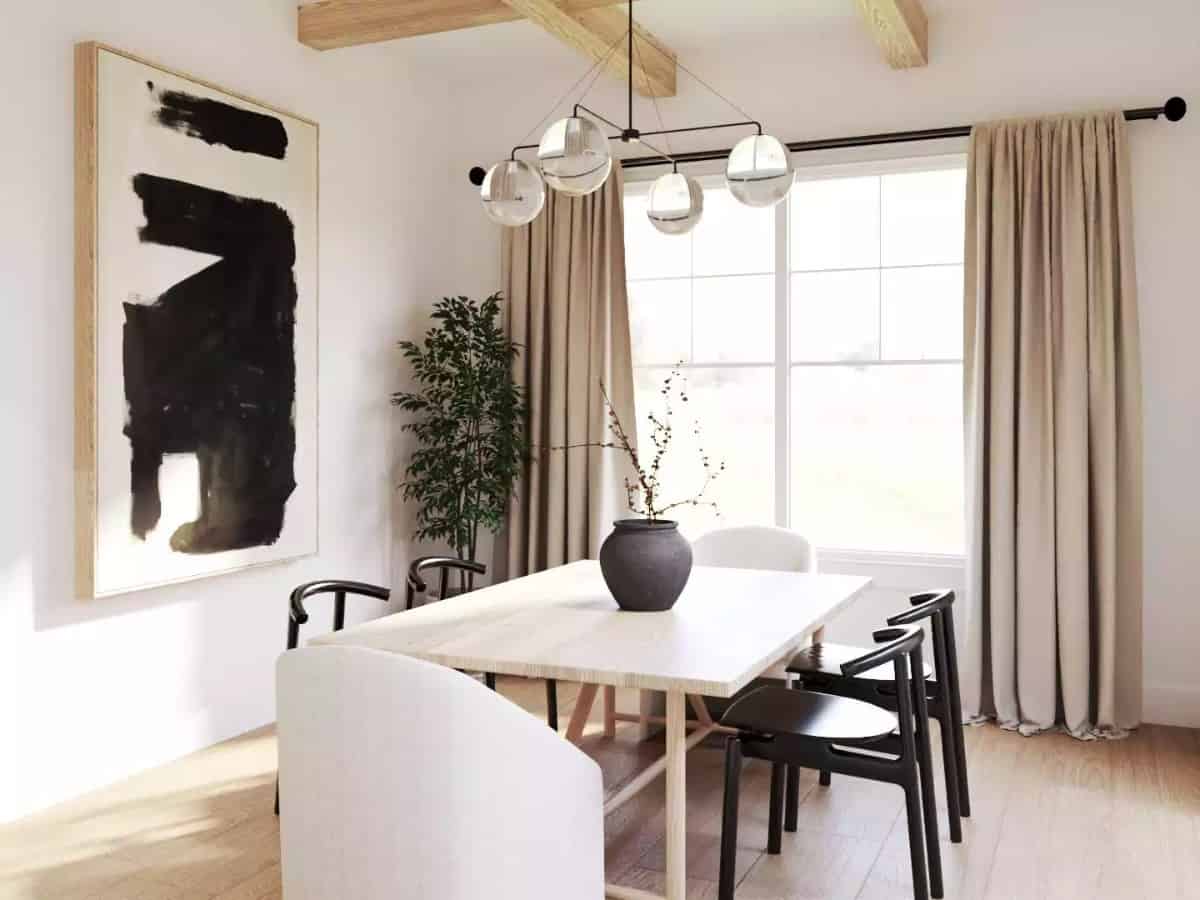 Dining room with a light wood table surrounded by black and white round-back chairs.