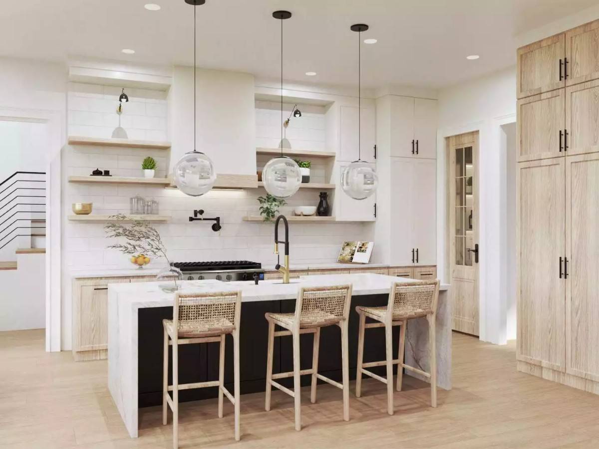 Kitchen with a waterfall island, floating shelves, and light wood cabinets that blend in with the hardwood floor.