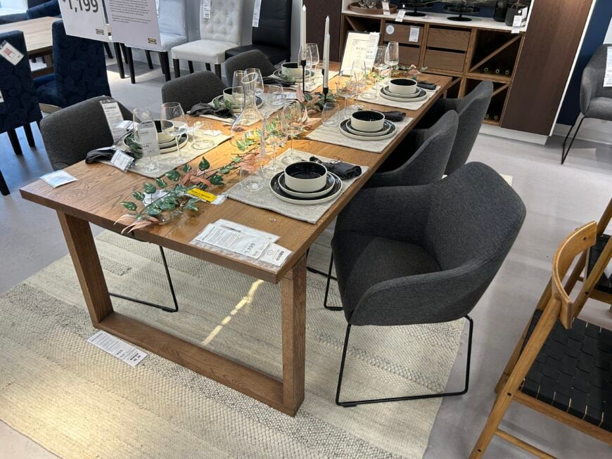 IKEA wooden dining table and gray chairs in the IKEA showroom