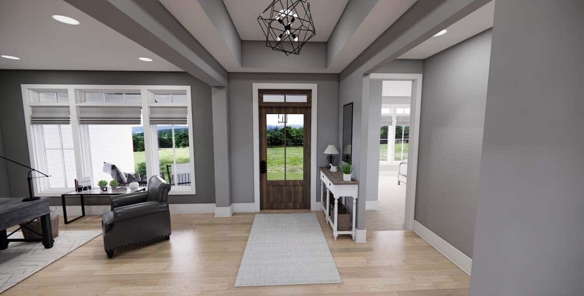 Foyer with a glazed entry door and a geometric chandelier hanging from the tray ceiling.