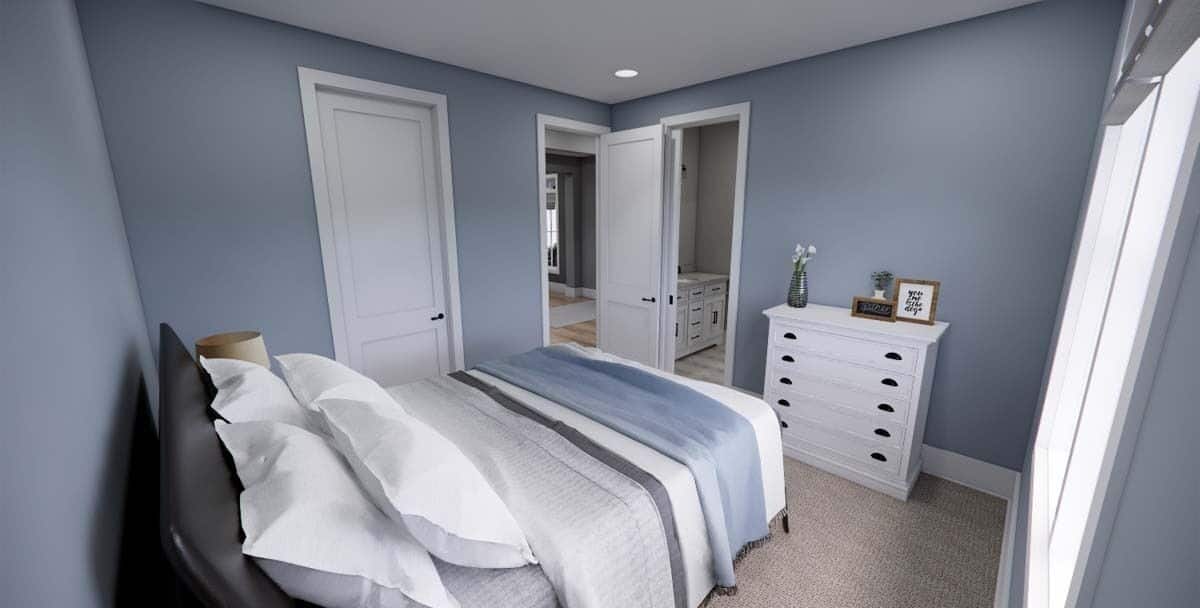Bedroom with light blue walls, a leather upholstered bed, and a white dresser.