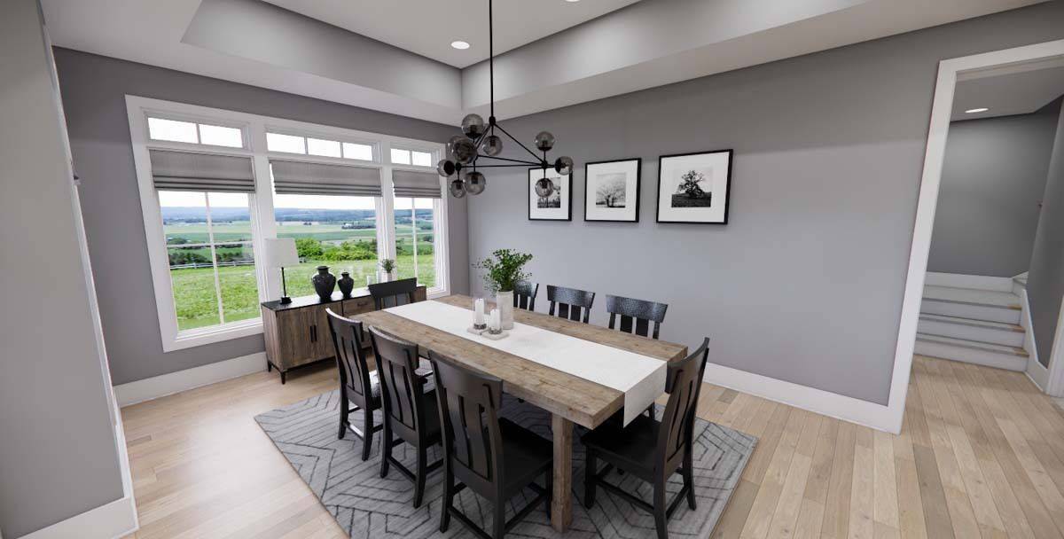 Dining room with a wooden buffet table and a matching dining set under a tray ceiling.