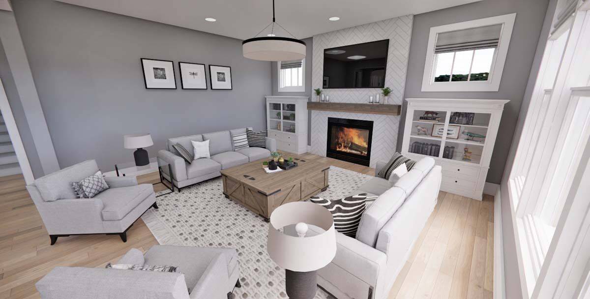 The great room includes white cabinets and a fireplace topped with a TV.