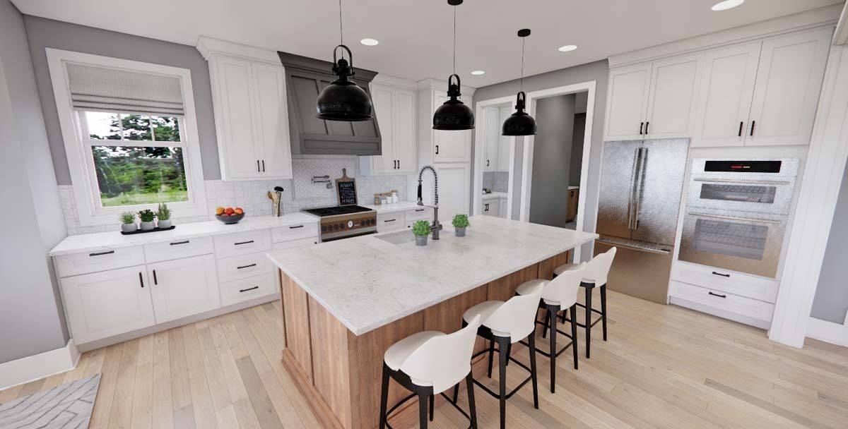 Kitchen with white cabinetry, stainless steel appliances, and a center island with a sink and casual seating.