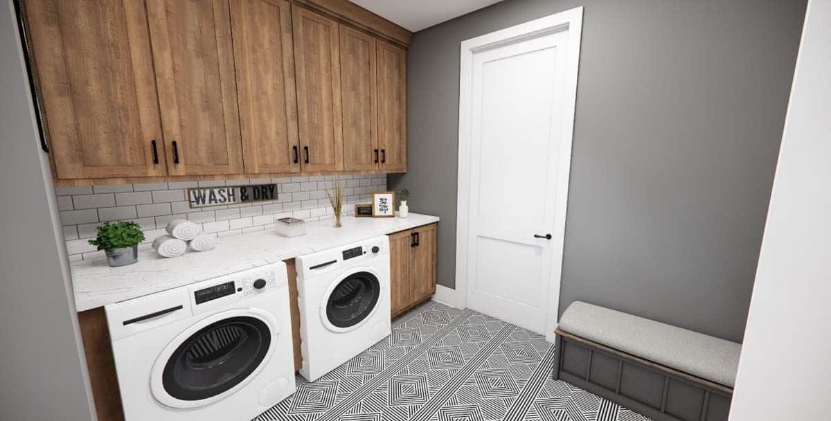 Mudroom with laundry appliances, wooden cabinets, and a cushioned bench.