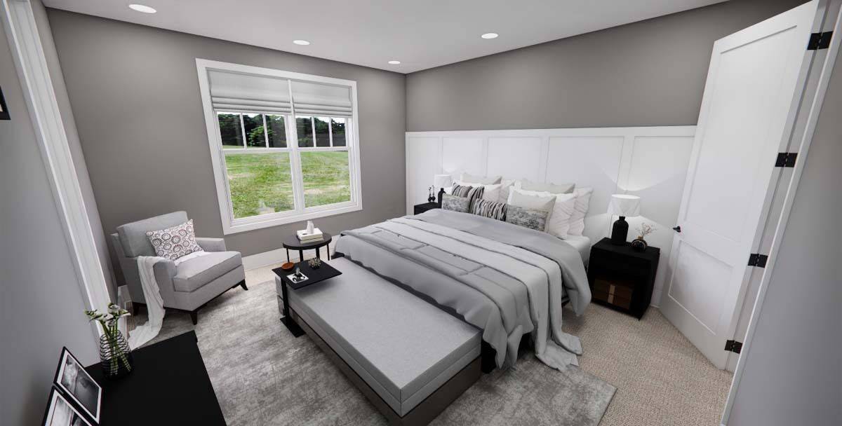 Primary bedroom with a cushioned armchair, and a wooden bed complemented with a sofa on its end.