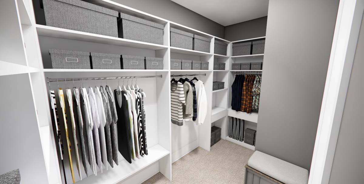 Primary walk-in closet with ample storage and a cushioned bench.