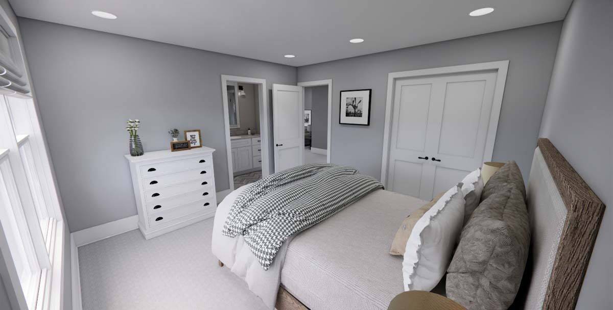 Secondary bedroom with a wooden bed, a white dresser, and an ensuite bathroom.