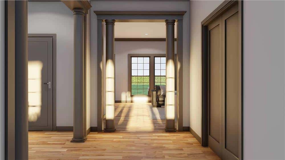 Foyer with round columns and double doors that reveal the study.