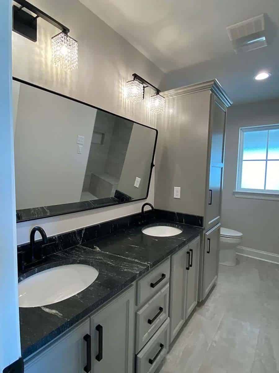 Primary bathroom with a dual sink vanity and a linen closet.