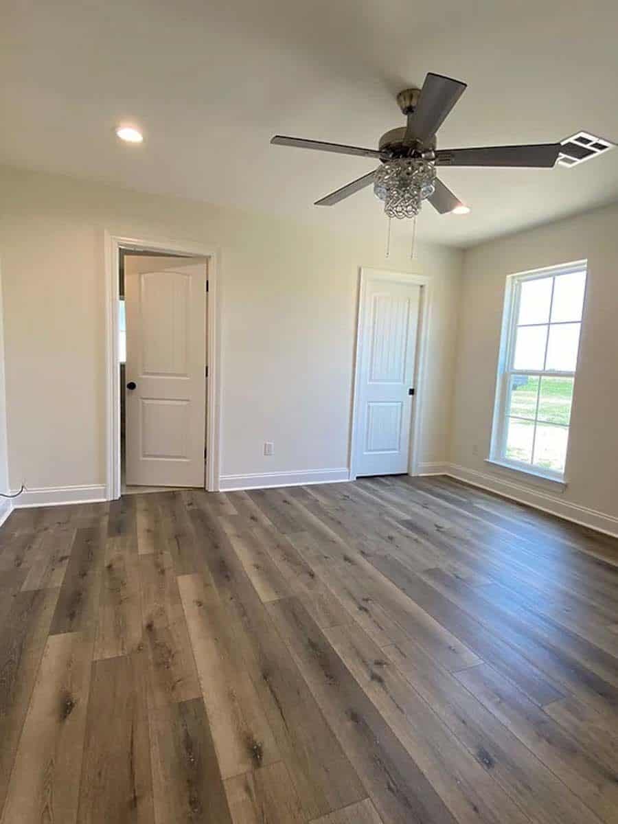Primary bathroom with a hardwood floor and an ensuite bathroom.