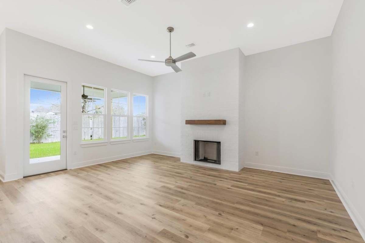 Great room with a fireplace and outdoor access through a glazed door.