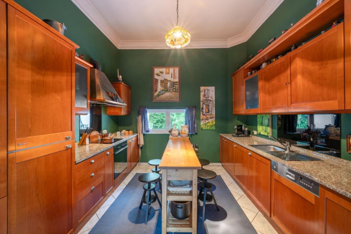 Kitchen with granite countertops, custom cabinets and tile flooring.