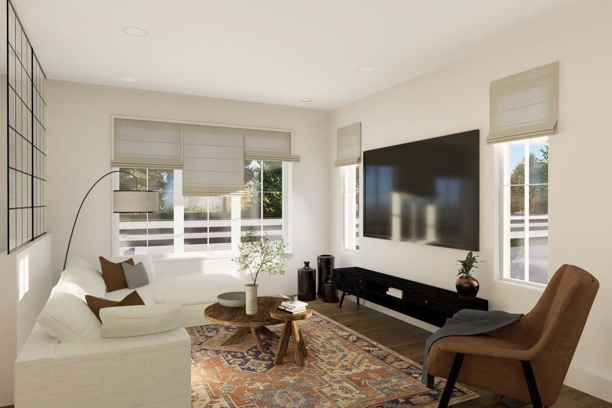 Family room with an L-shaped sofa, a velvet chair, and a large TV mounted above the black console table.
