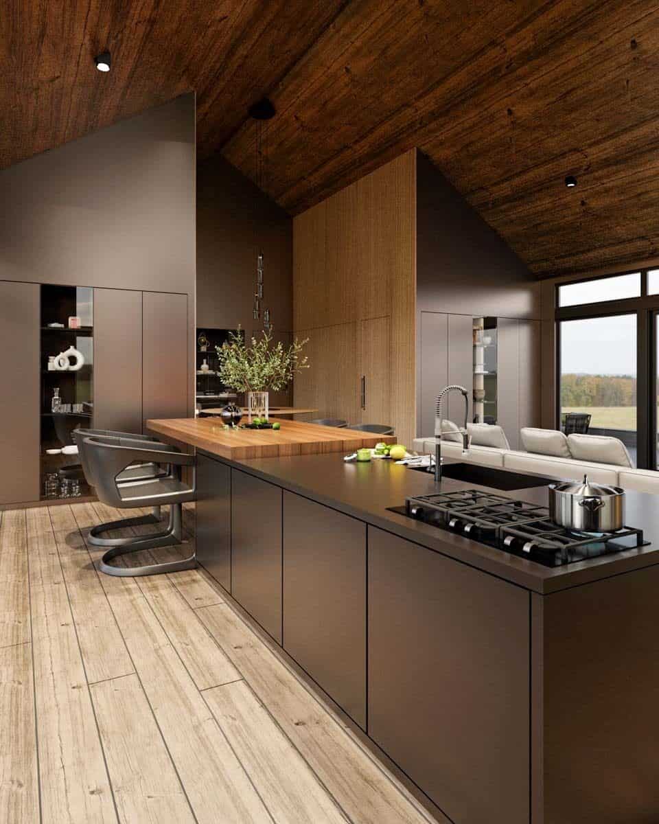 Kitchen with custom cabinetry and a center island with a wooden eating counter.