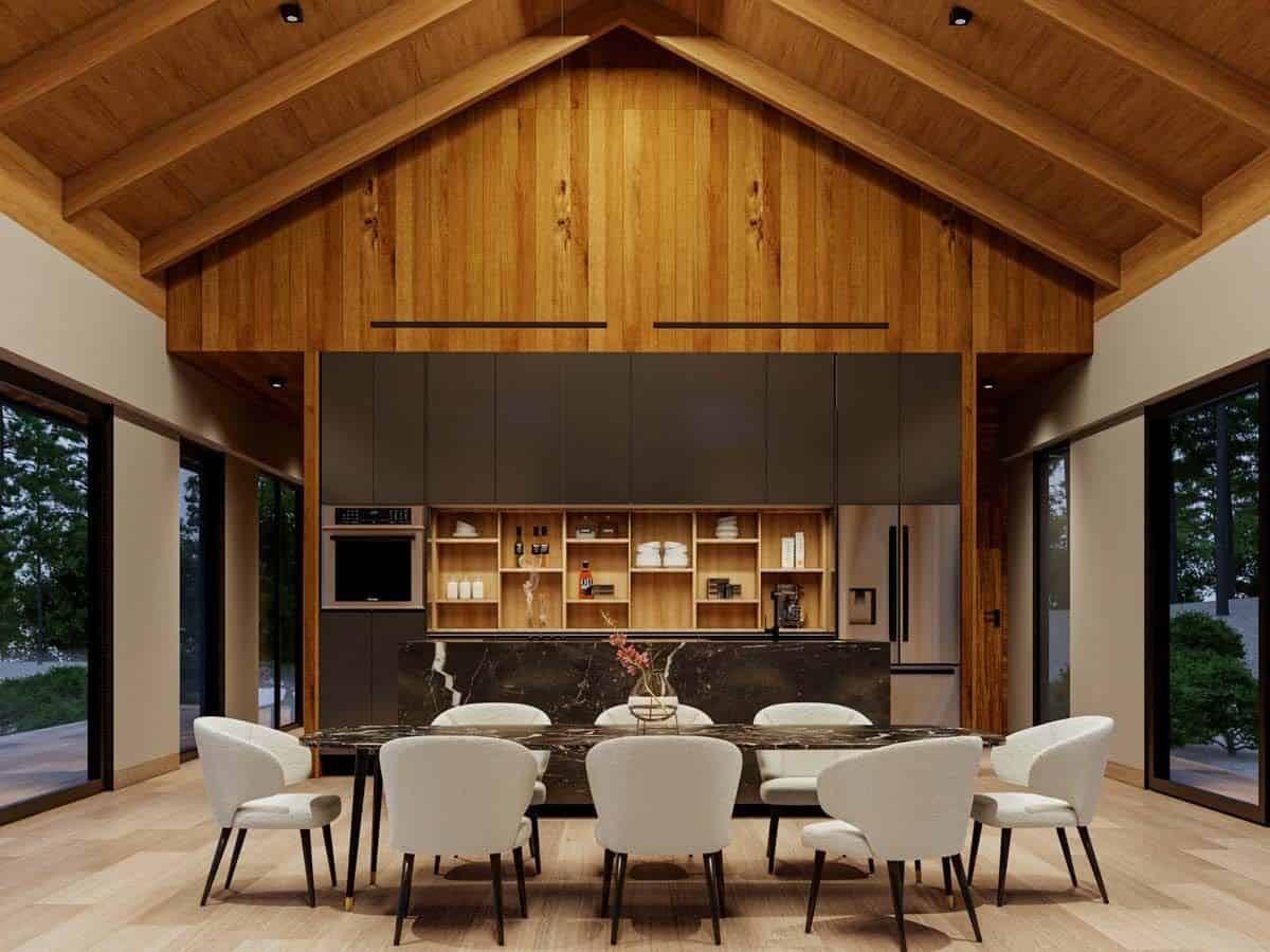 Eat-in kitchen with custom cabinetry, a breakfast island, and a contemporary dining set under a cathedral ceiling with exposed wood beams.
