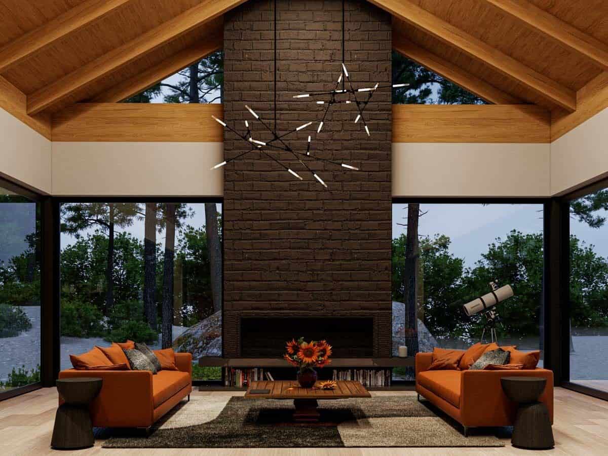 Living room with modern sofas, a brick fireplace, and wrought iron chandeliers hanging from the cathedral ceiling.