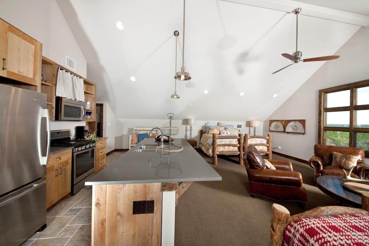 Studio with kitchen, dining area, and bed space.