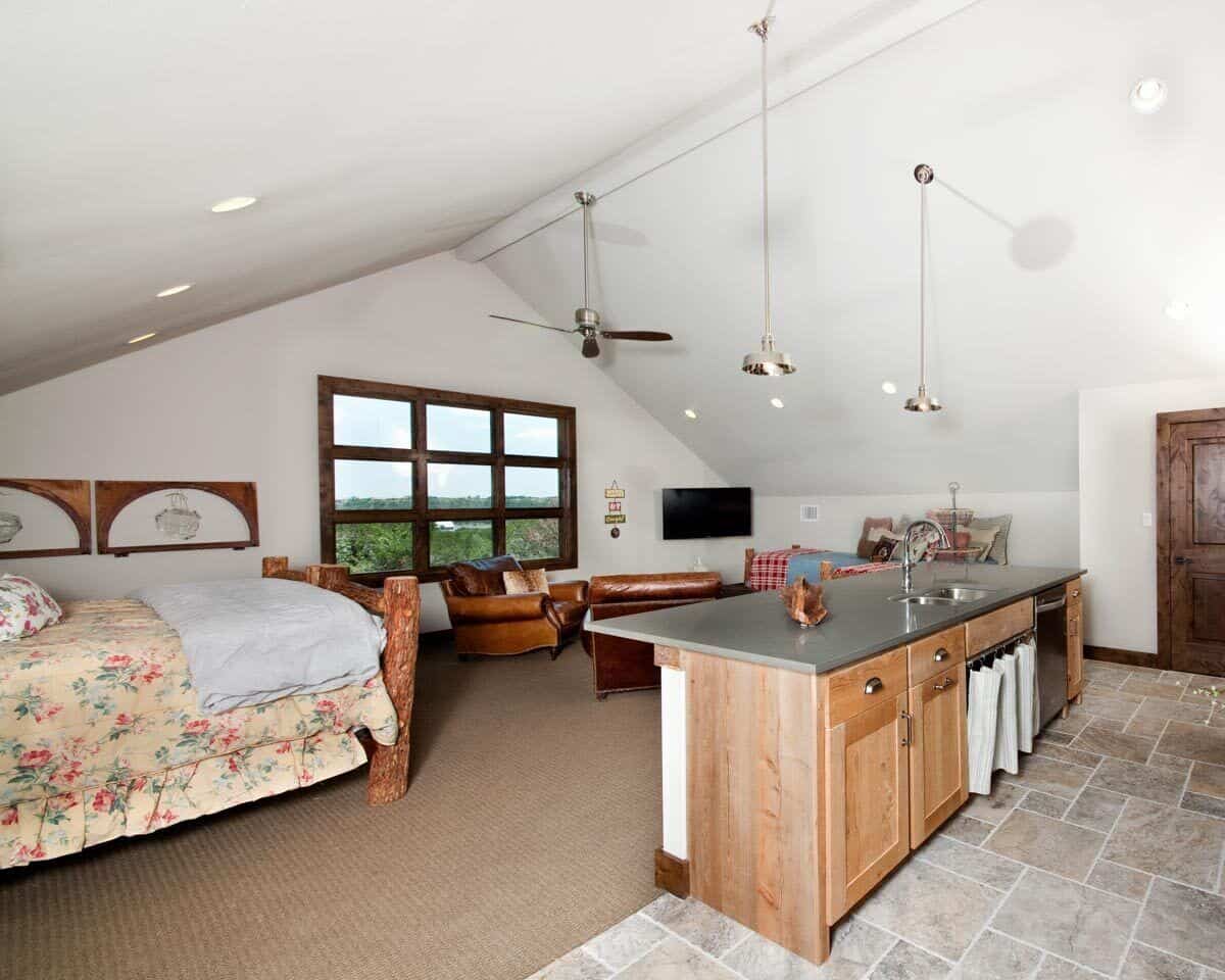 Living area and bed space under a cathedral ceiling.