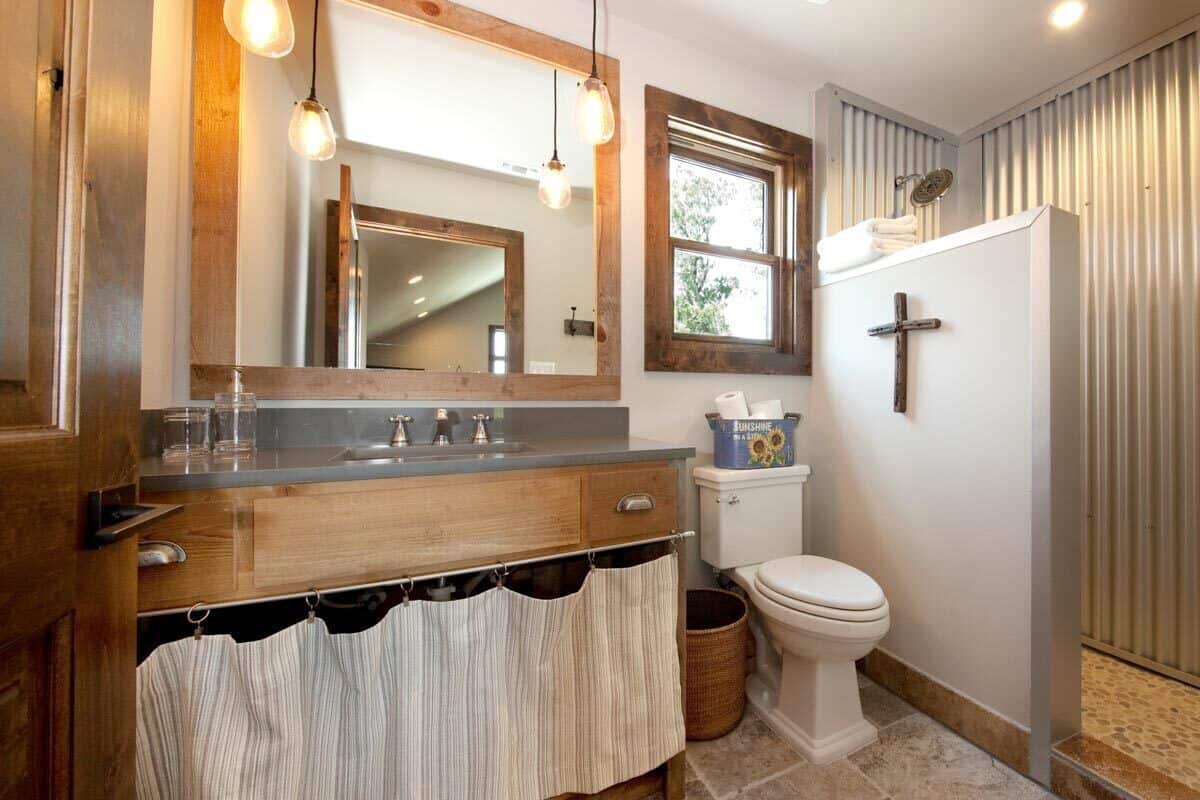 Bathroom with a sink vanity, a toilet, and a walk-in shower.
