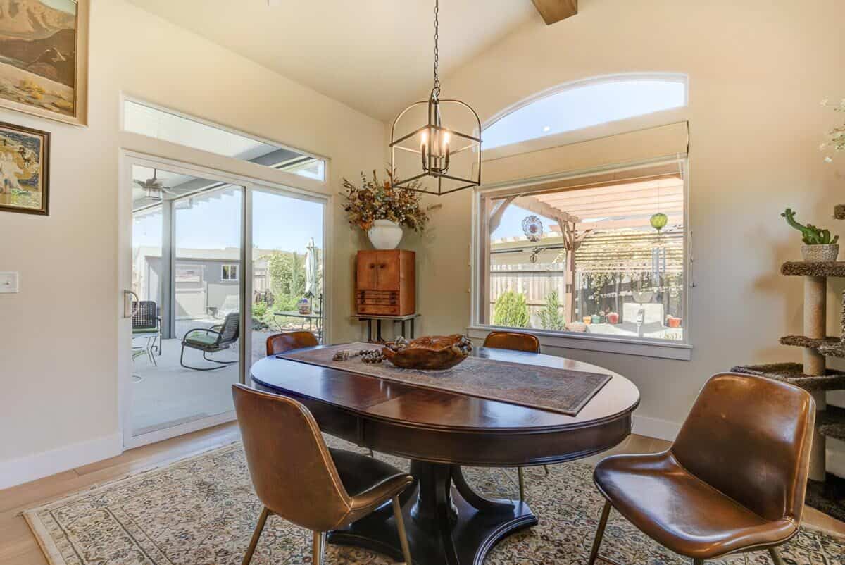 Dining room with a round dining set and sliding glass doors that open to the rear patio.