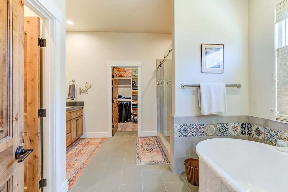 Primary bathroom with a soaking tub, a tiled shower, and a walk-in closet.