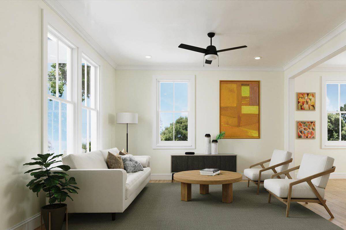 Living room with beige seats and a round coffee table over the gray area rug.