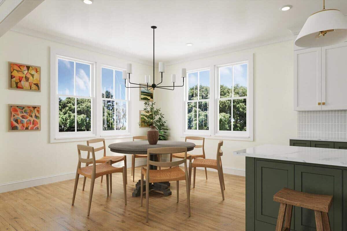 Dining area with a round dining table paired with wooden chairs.