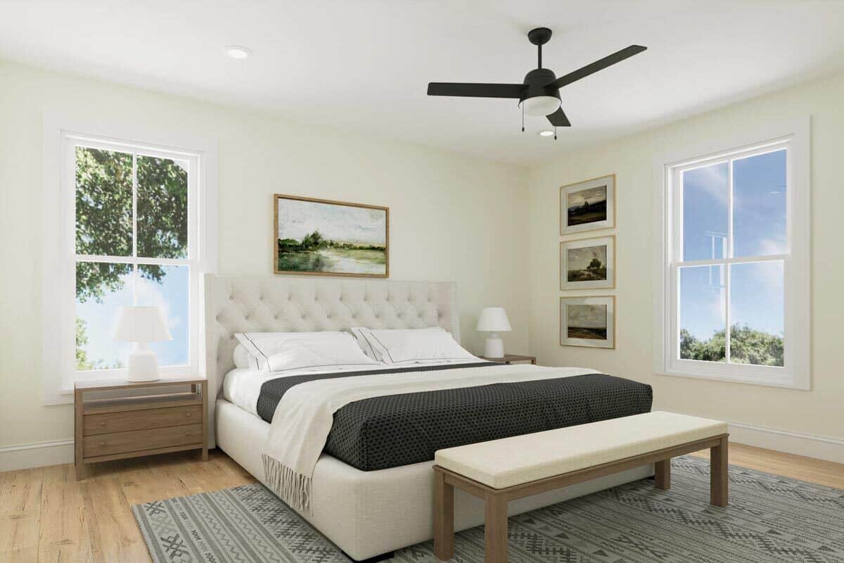 Primary bedroom with wooden nightstands and a tufted bed complemented with a cushioned bench.