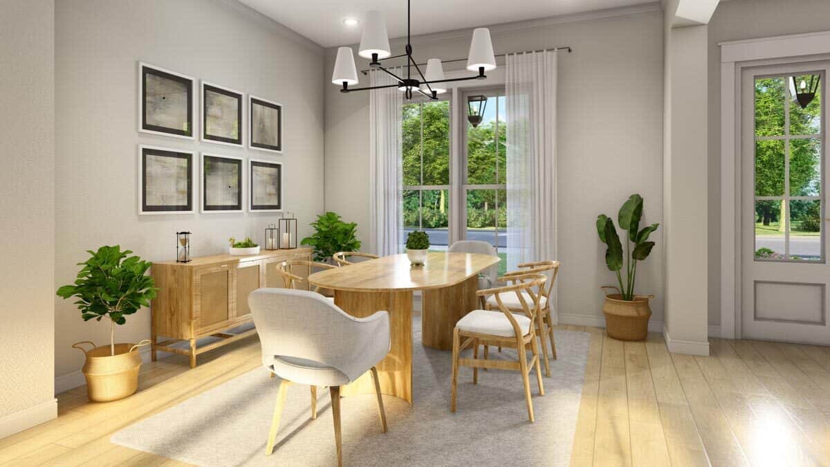 Dining room with an oval dining set and a matching buffet table adorned with a photo gallery.