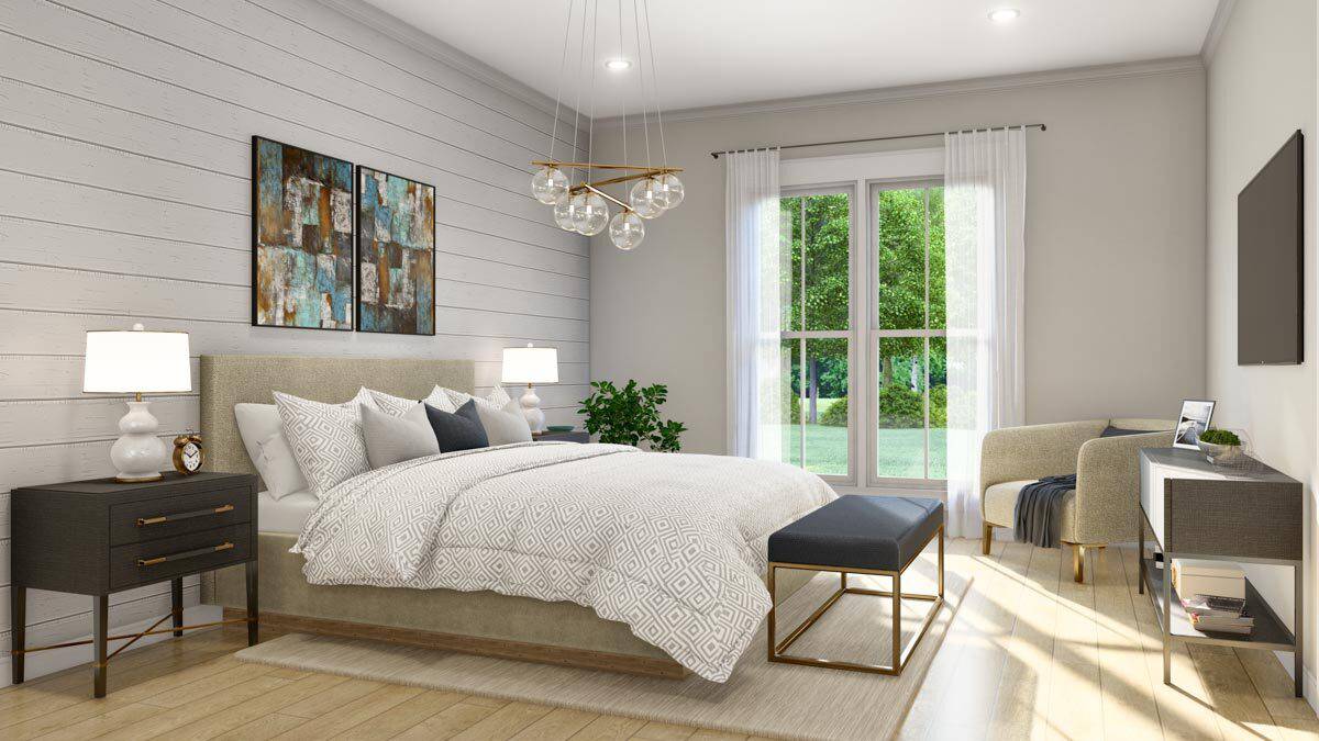 Primary bedroom with a round back chair and an upholstered bed complemented with a cushioned bench.