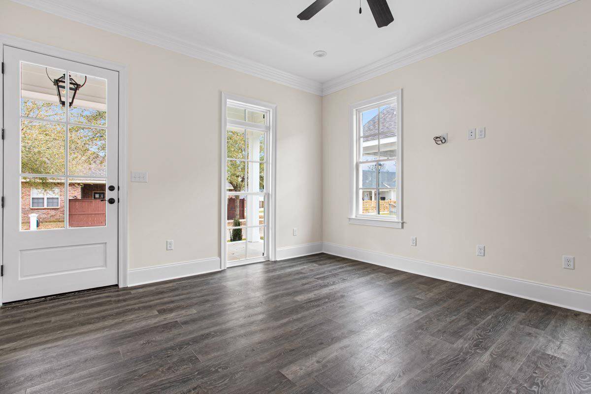 Living room with a glazed front door and white-framed windows.