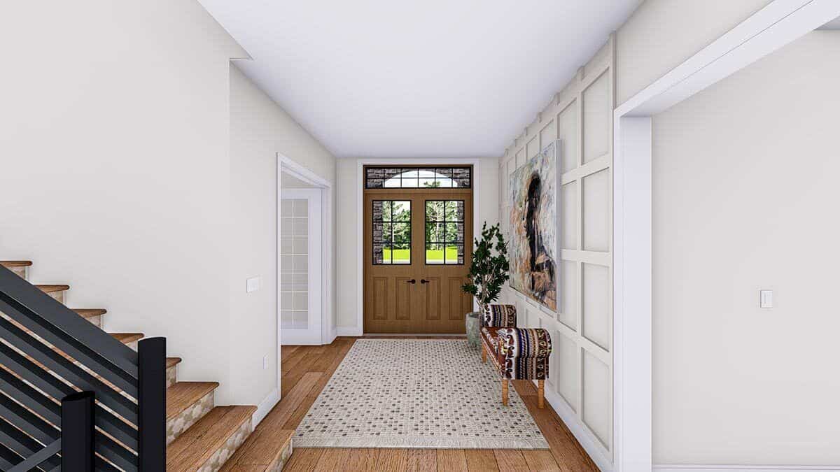 Foyer with a French front door, a wood-paneled accent wall, and a large rug that lays on the hardwood floor.