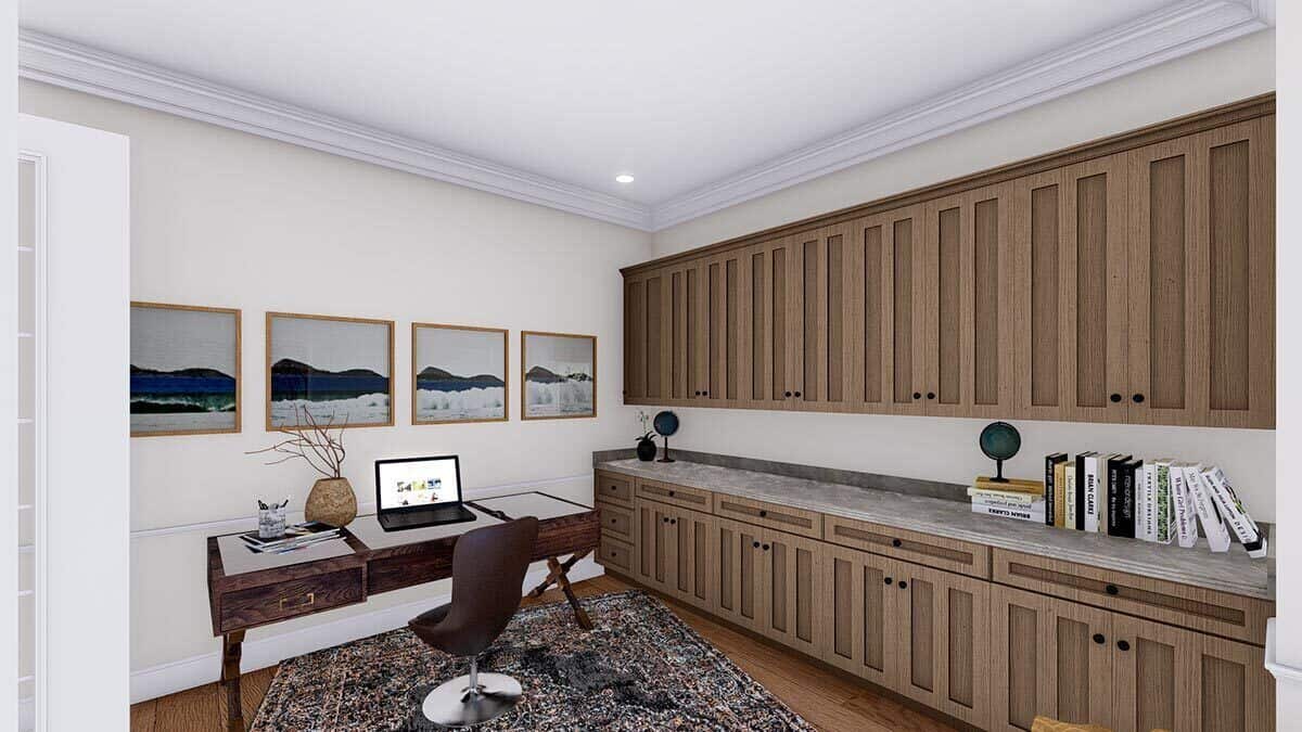 Home office with a wooden desk and a wall of built-in cabinets.