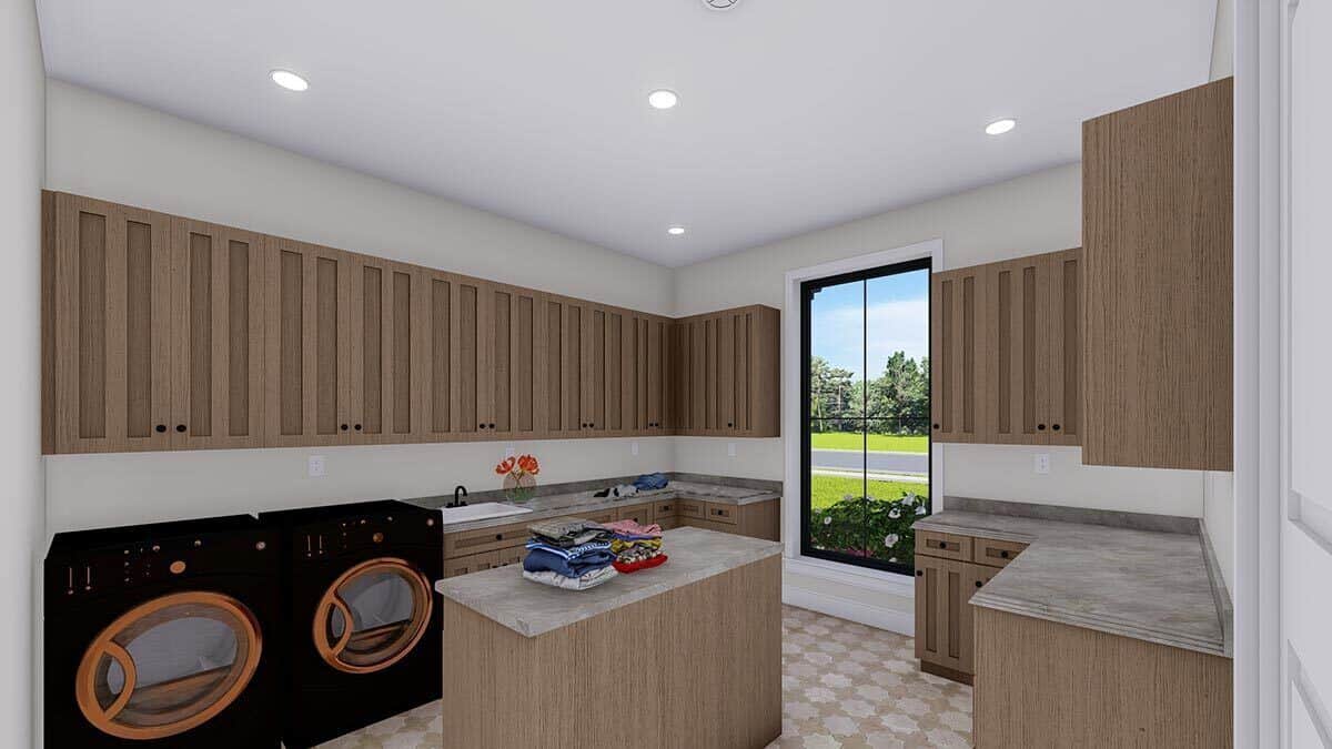 Laundry room with wooden cabinets, marble countertops, a center island, and a large window allowing natural light in.