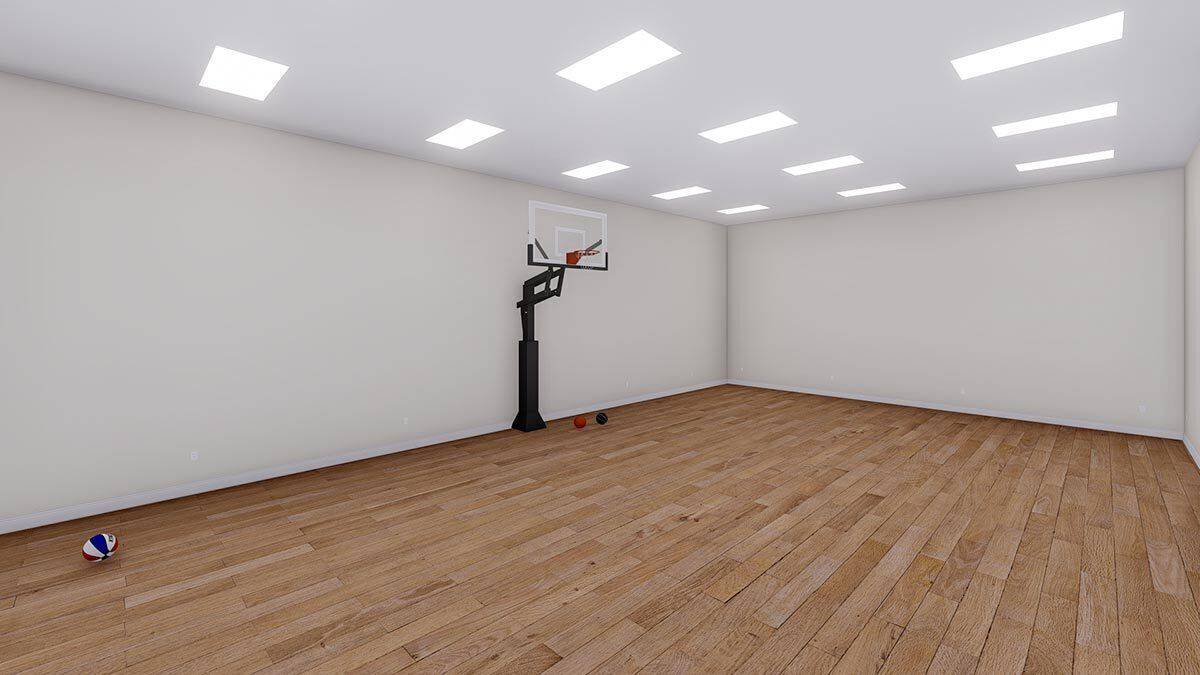 Sport court with hardwood flooring and a basketball ring.