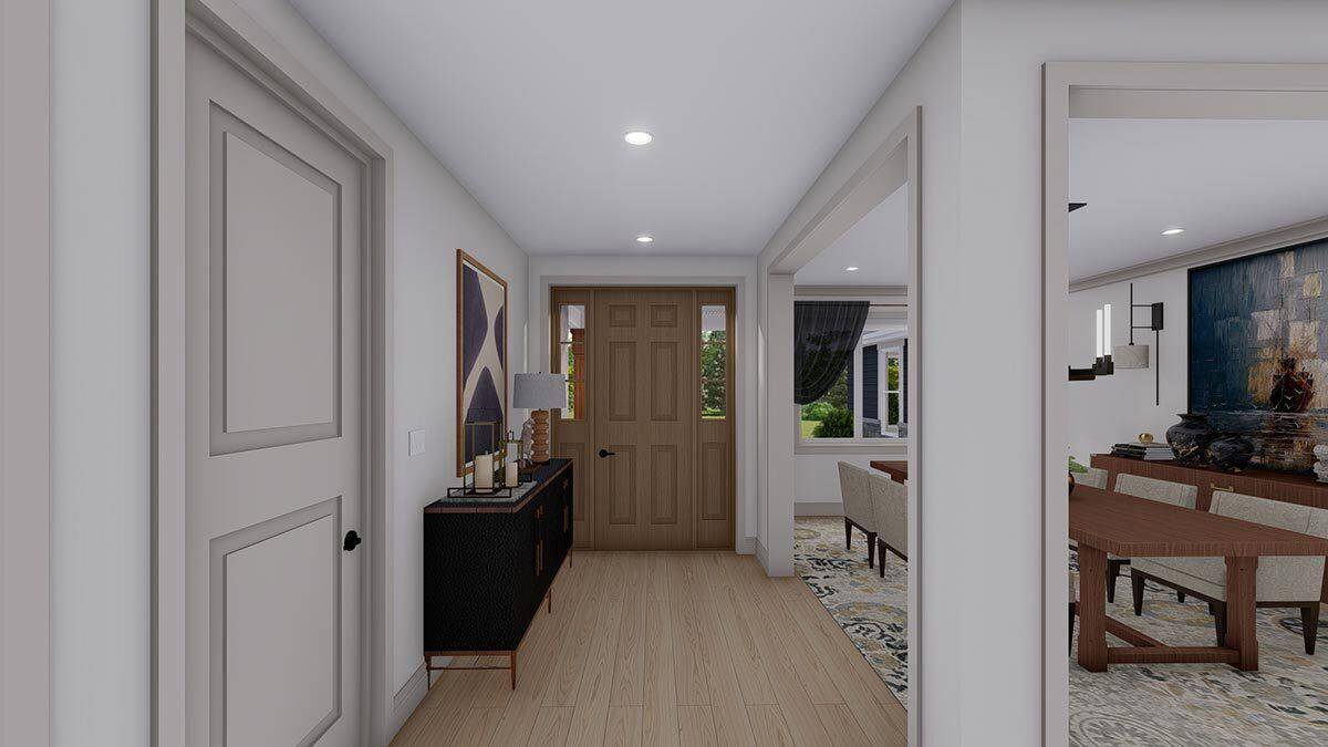 Foyer with a wooden front door and a dark wood table adorned with a framed artwork.
