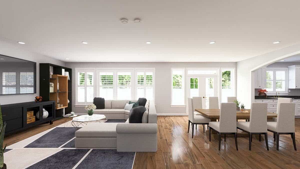 Family room and dining room with hardwood flooring and a wall of windows bringing ample natural light in.