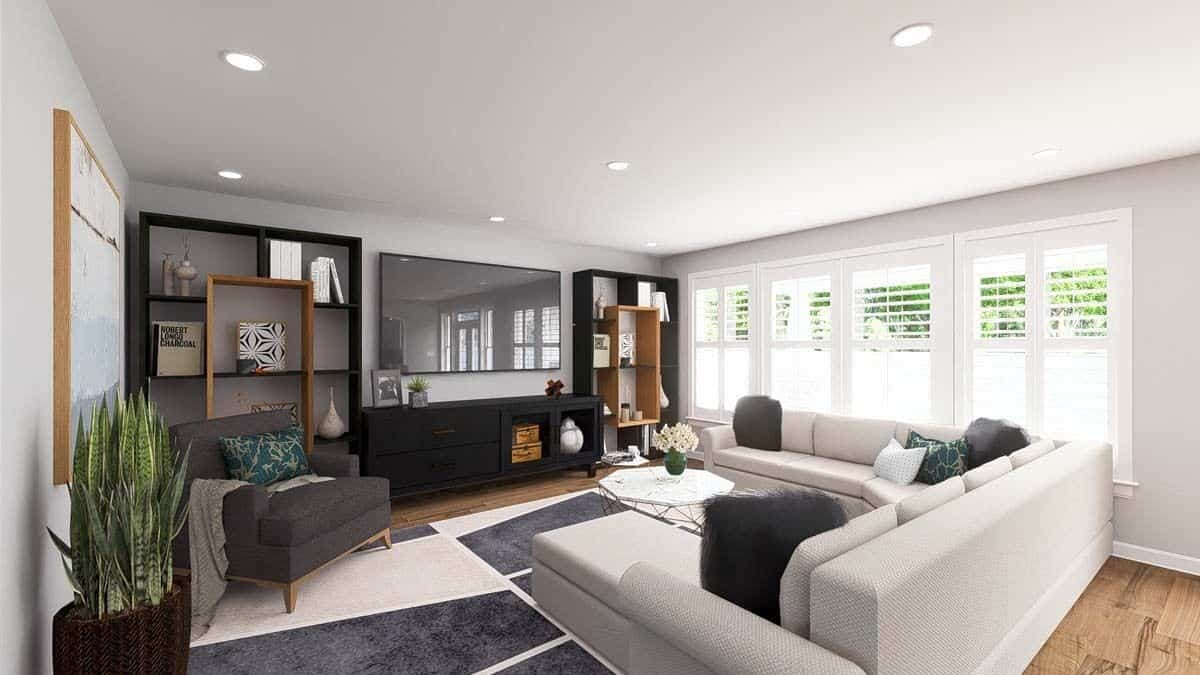 Family room with a U-shaped sofa, a cushioned armchair, and a large wall-mounted TV.