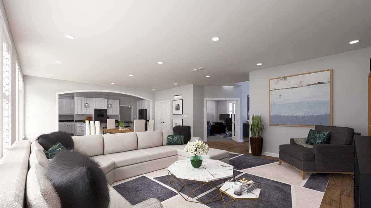 The family room includes marble-top coffee tables sitting on a patterned area rug.