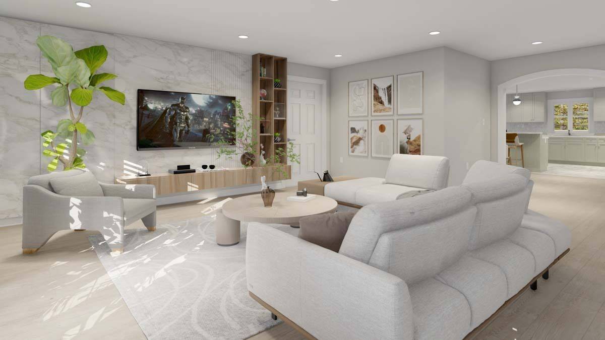 Family room with modern seats, a round coffee table, and a large TV mounted above the built-in console table.