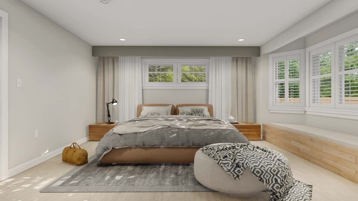 Primary bedroom with a window seat nook and a platform bed complemented with wooden nightstands and a round ottoman.