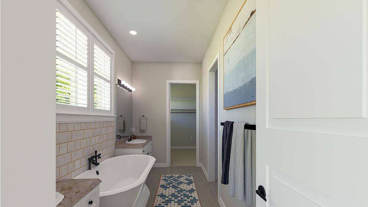 Primary bathroom with a walk-in shower and a soaking tub flanked by his and her vanities.