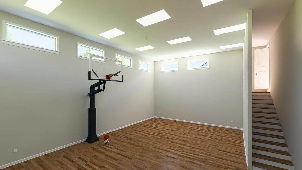 Sports court with clerestory windows and a hardwood floor.
