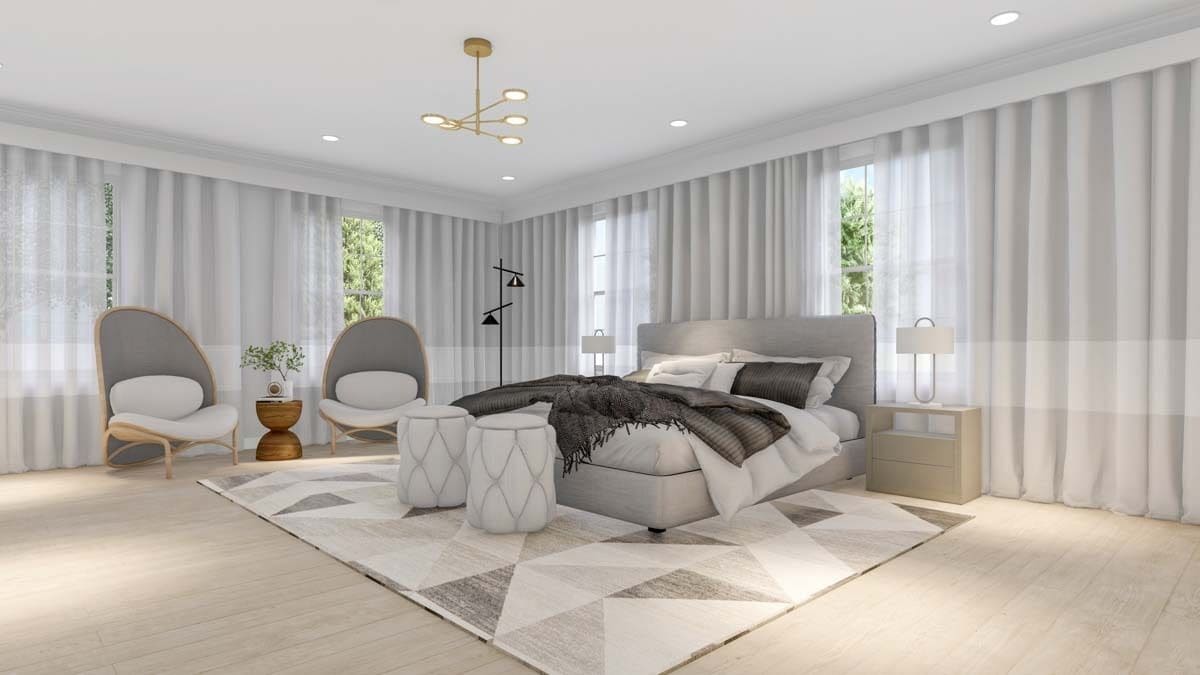 Primary bedroom with round back chairs and a platform bed over a geometric area rug.