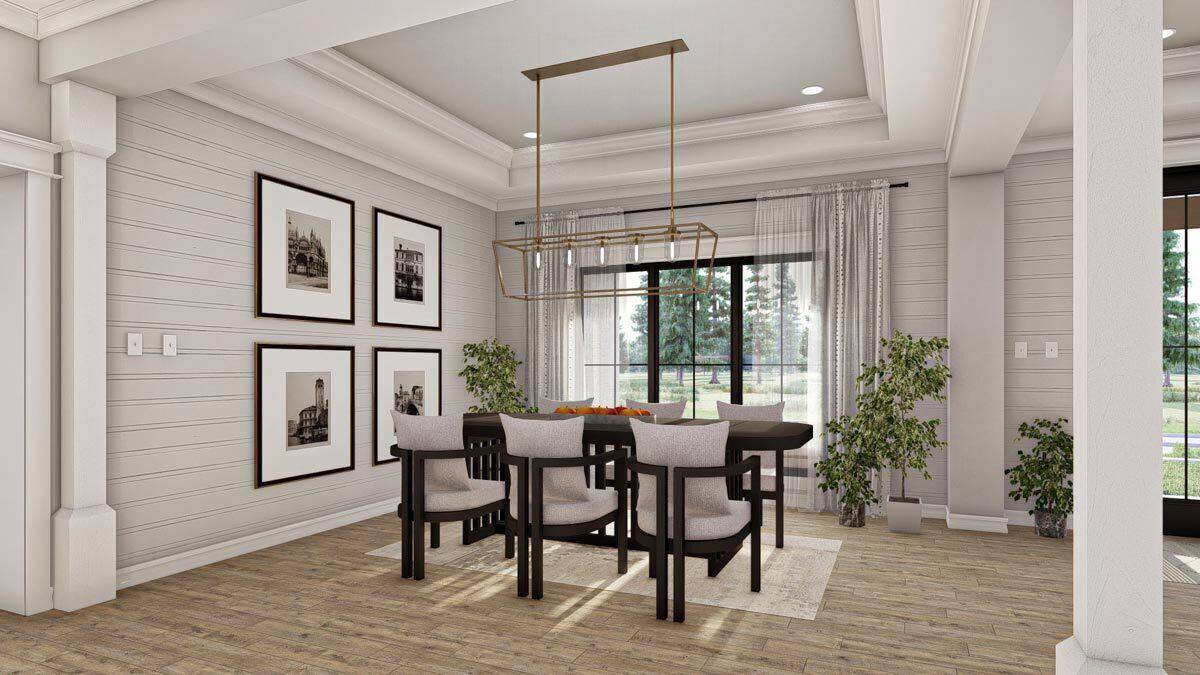 Dining room with a dark wood dining set and a linear chandelier hanging from the tray ceiling.