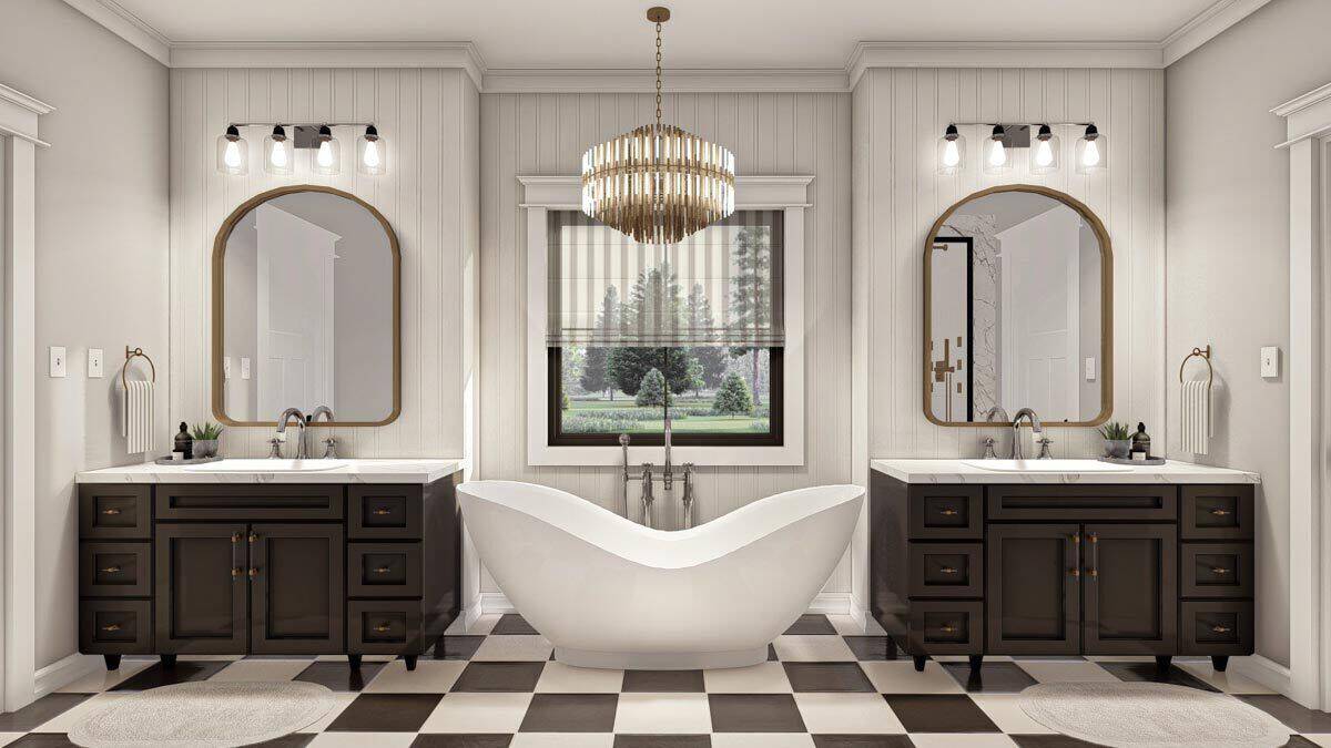 Primary bathroom with his and her vanities flanking the freestanding tub.