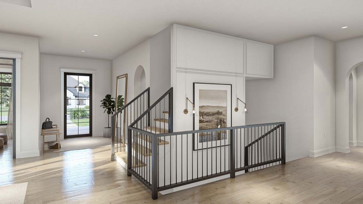 Foyer with a glazed front door and staircases leading to the upstairs bedrooms and basement.